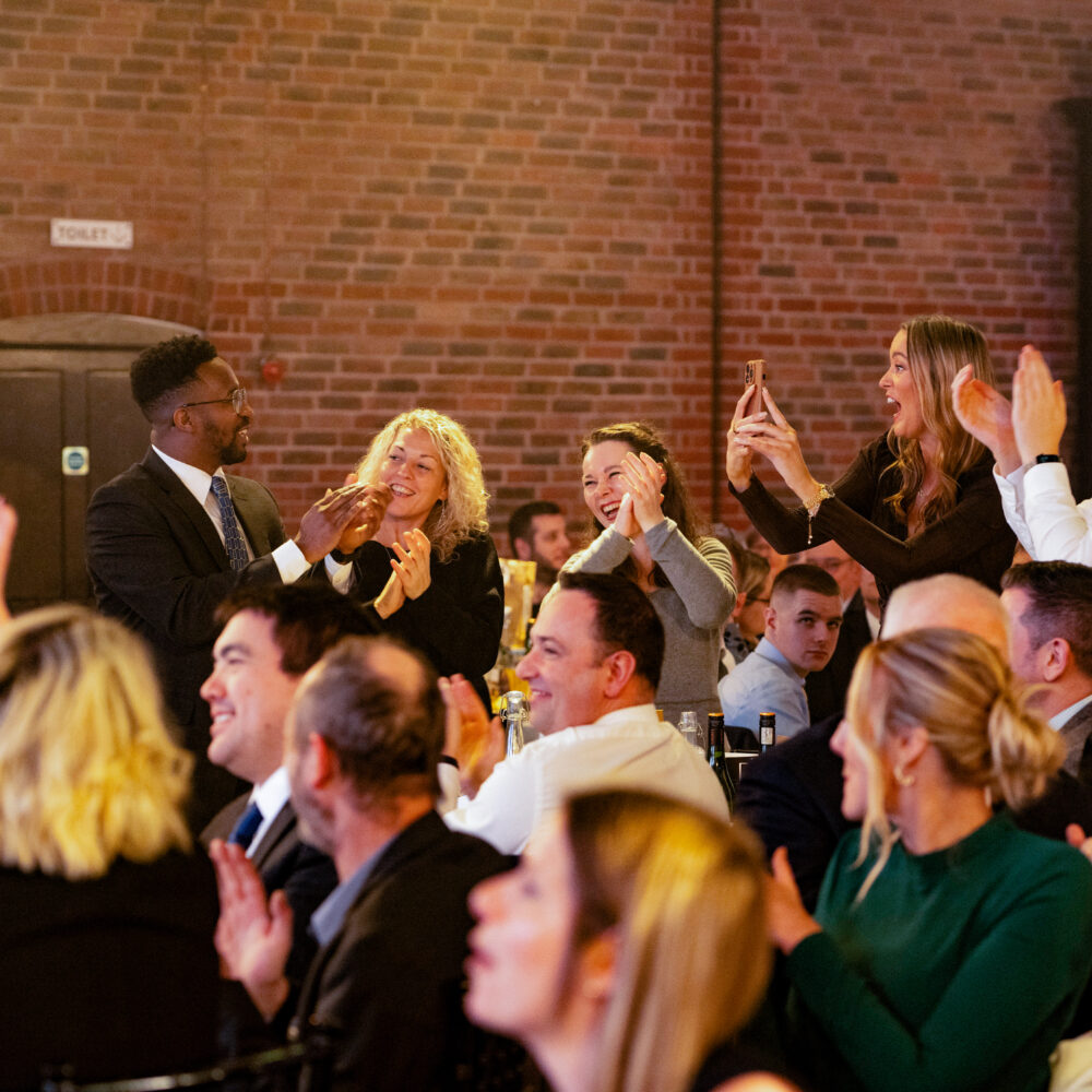 BIFA Staff Development Award recipients clapping for OIA Global's victory at the annual Freight Awards ceremony.